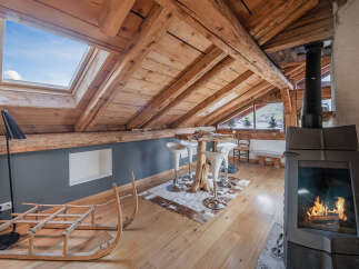 Discover the charm of this unique property, featuring a cozy interior with exposed wooden beams and a skylight that floods the space with natural light.