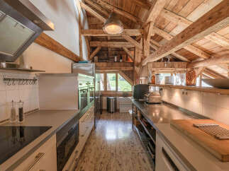 This stunning kitchen showcases a unique blend of rustic charm and modern design.