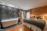 Experience luxury in this stunning property featuring a spacious bedroom and a spa-like bathroom.