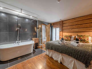 Experience luxury in this stunning property featuring a spacious bedroom and a spa-like bathroom.
