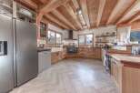 This stunning kitchen boasts a warm and inviting atmosphere with its wooden beams and cabinetry.