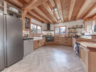 This stunning kitchen boasts a warm and inviting atmosphere with its wooden beams and cabinetry.