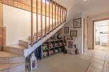 Discover the charm of this inviting home, featuring a beautifully designed staircase with wooden accents.
