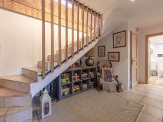 Discover the charm of this inviting home, featuring a beautifully designed staircase with wooden accents.