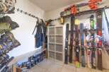 Organize your gear in style with this well-equipped ski storage room! Featuring a convenient bench, ample storage for boots and equipment, and a dedicated space for skis, this room is perfect for any winter sports enthusiast.