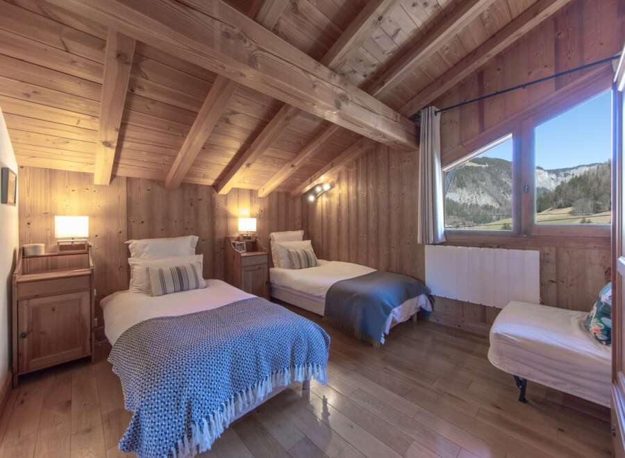 This cozy bedroom features a rustic wooden design, creating a warm and inviting atmosphere.