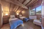 This cozy bedroom features a rustic wooden design, creating a warm and inviting atmosphere.