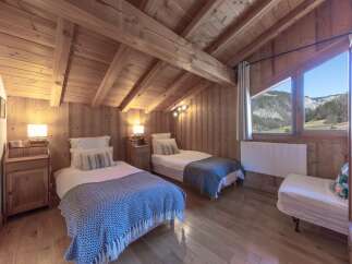 This cozy bedroom features a rustic wooden design, creating a warm and inviting atmosphere.