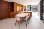 This stunning property features a modern kitchen with custom cabinetry and a luxurious marble dining table.