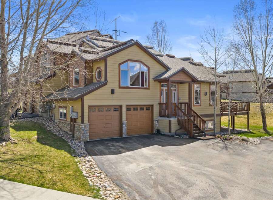 This stunning property boasts a beautiful exterior with a combination of stone and wood accents.