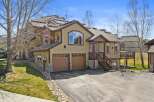 This stunning property boasts a beautiful exterior with a combination of stone and wood accents.
