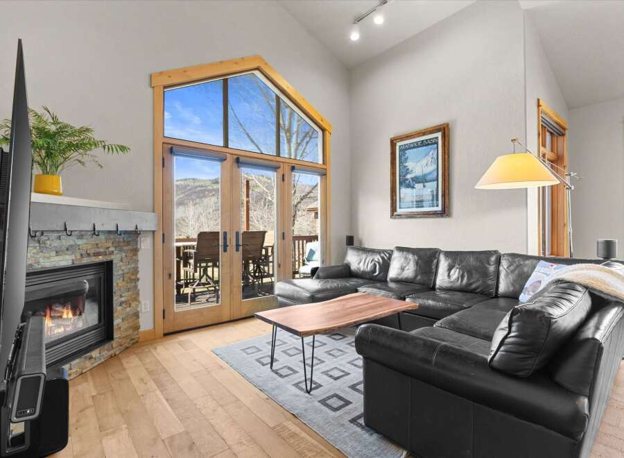Experience luxury living in this stunning property, featuring a cozy fireplace and expansive windows that flood the space with natural light.