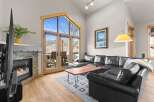 Experience luxury living in this stunning property, featuring a cozy fireplace and expansive windows that flood the space with natural light.