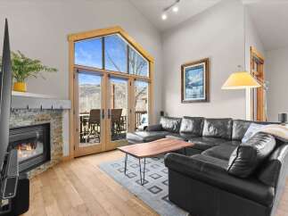 Experience luxury living in this stunning property, featuring a cozy fireplace and expansive windows that flood the space with natural light.