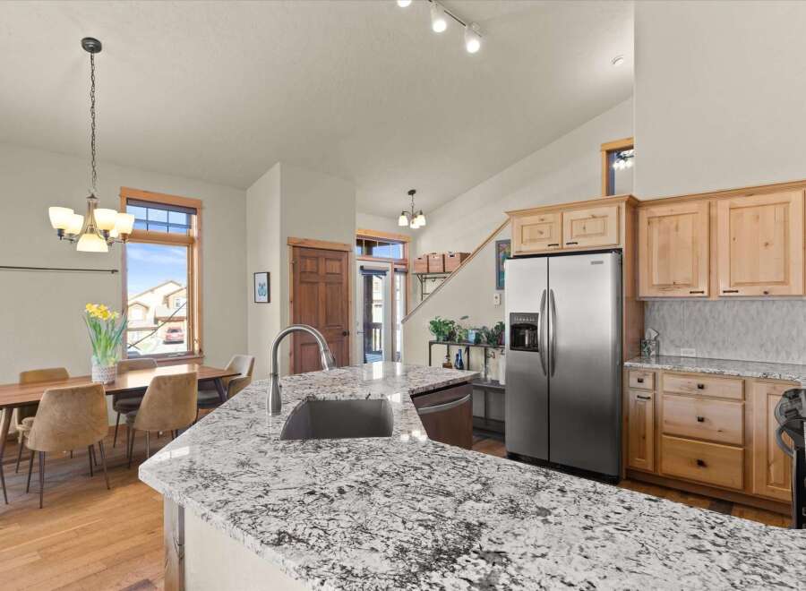 This stunning kitchen boasts a modern design with granite countertops, perfect for meal preparation and entertaining.
