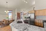 This stunning kitchen boasts a modern design with granite countertops, perfect for meal preparation and entertaining.