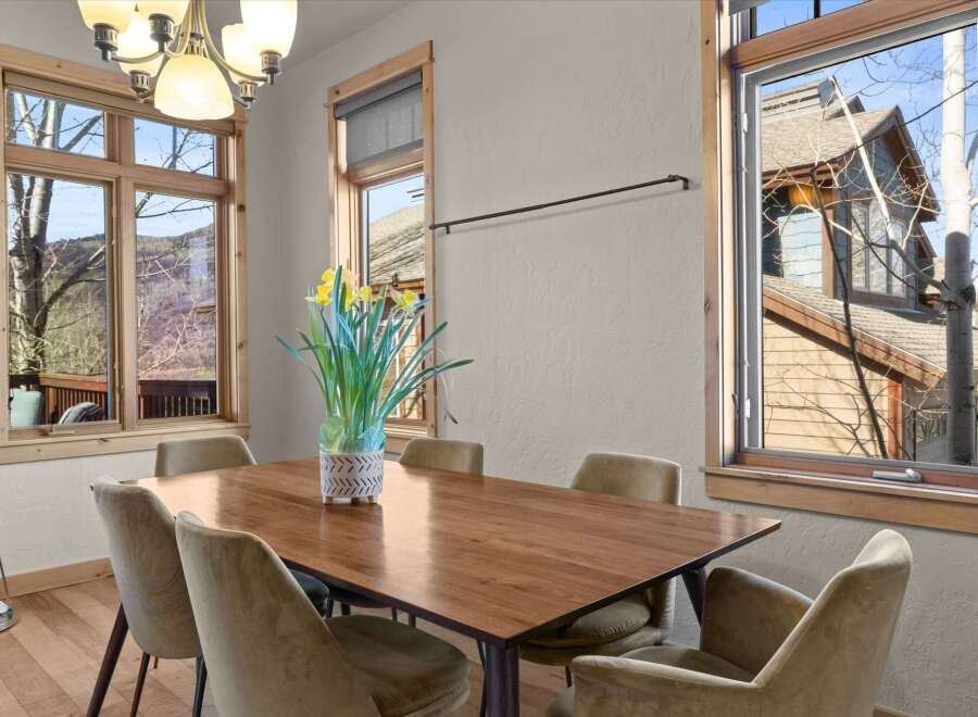 This stunning dining room boasts a warm and inviting atmosphere, perfect for hosting gatherings.