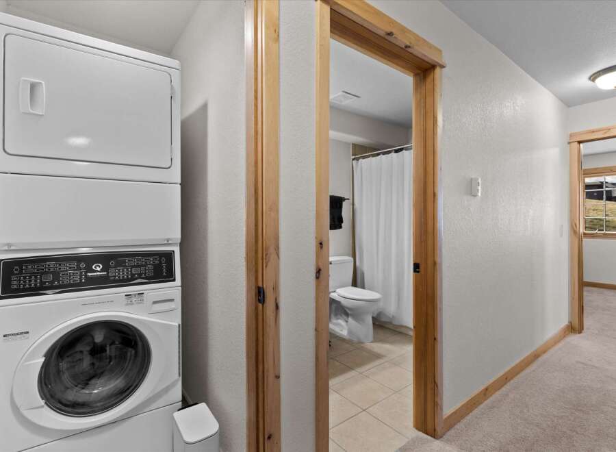 This property features a convenient laundry area with a stacked washer and dryer, perfect for modern living.