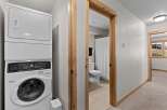 This property features a convenient laundry area with a stacked washer and dryer, perfect for modern living.