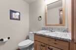 Step into this beautifully designed bathroom, featuring a stylish vanity with a granite countertop and ample storage.