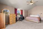 This inviting bedroom boasts a cozy ambiance with its neutral color palette and ample natural light.