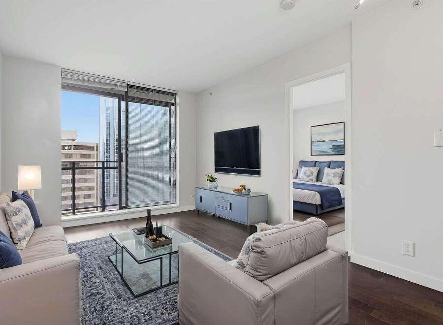 Experience luxury living in this stunning apartment! This property boasts a modern design with a spacious living area, a sleek TV, and a beautiful view.