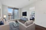 Experience luxury living in this stunning apartment! This property boasts a modern design with a spacious living area, a sleek TV, and a beautiful view.