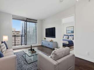 Experience luxury living in this stunning apartment! This property boasts a modern design with a spacious living area, a sleek TV, and a beautiful view.