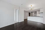 This modern apartment boasts a sleek, open-concept design with a gourmet kitchen featuring stainless steel appliances.