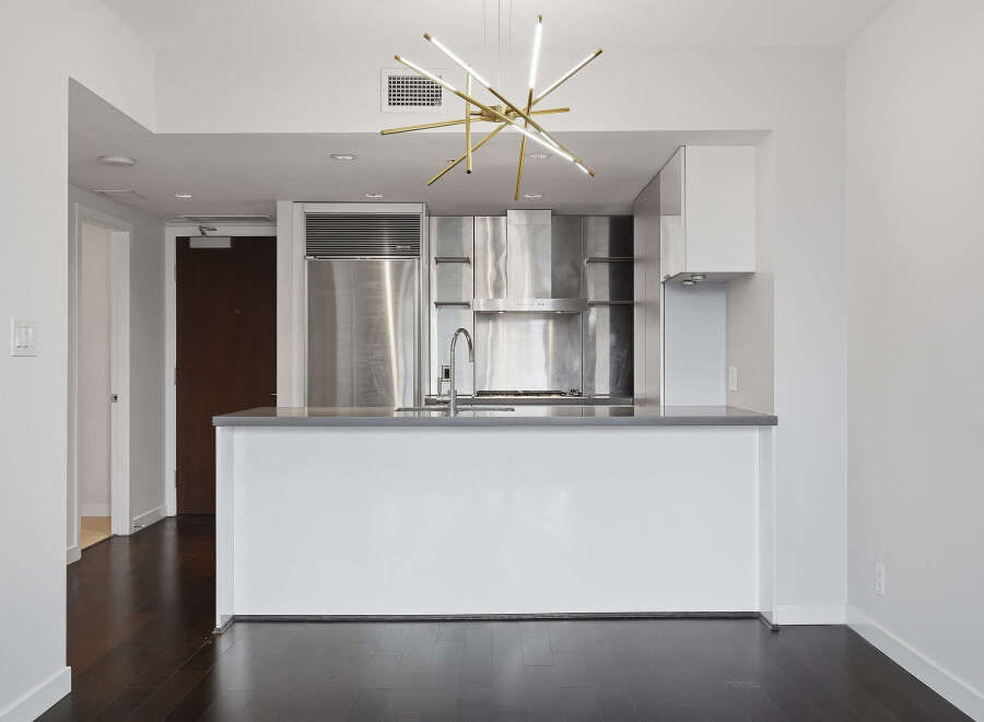 Experience modern luxury in this stunning kitchen! Featuring stainless steel appliances, a sleek island, and a stylish light fixture, this space is perfect for both cooking and entertaining.