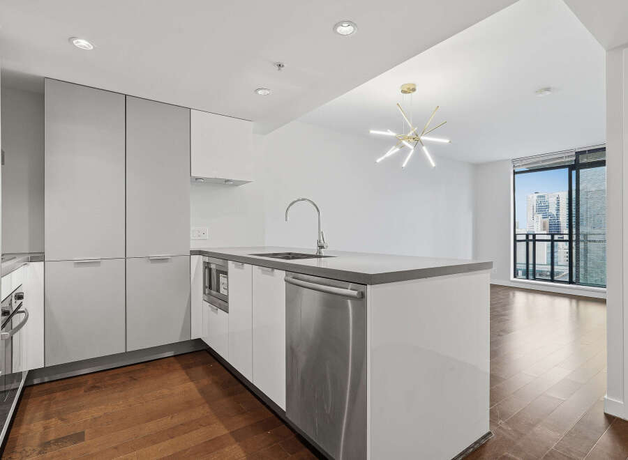 Experience modern living in this stunning kitchen! Featuring sleek cabinetry, stainless steel appliances, and a spacious island, this kitchen is perfect for both cooking and entertaining.