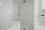 Step into luxury with this stunning bathroom featuring a sleek glass shower enclosure.