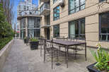 Enjoy outdoor dining at this stunning property! This image showcases a beautiful patio area with elegant metal tables and chairs, perfect for entertaining or relaxing.