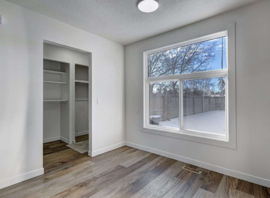 Step into this bright and airy room, featuring a large window that floods the space with natural light.