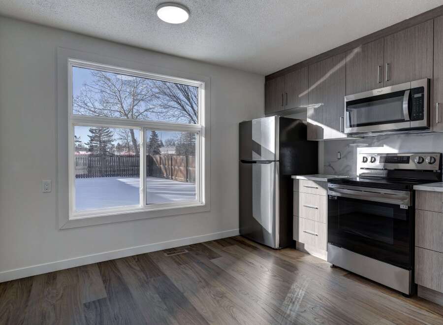Step into this stunning kitchen, boasting modern appliances and sleek cabinetry.