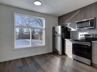 Step into this stunning kitchen, boasting modern appliances and sleek cabinetry.