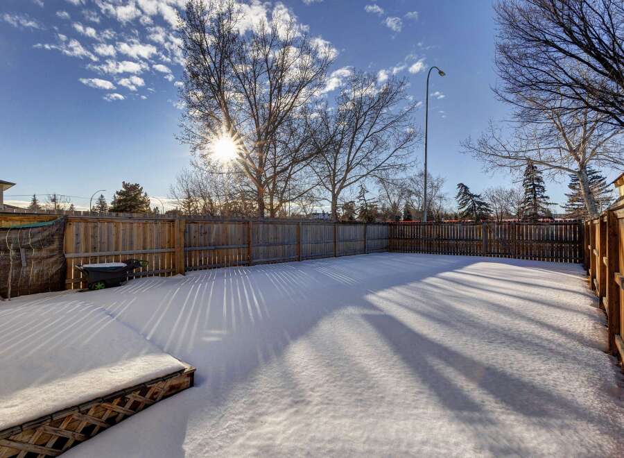 Enjoy the winter wonderland in this spacious backyard, perfect for creating lasting memories.