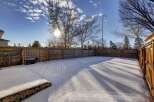 Enjoy the winter wonderland in this spacious backyard, perfect for creating lasting memories.