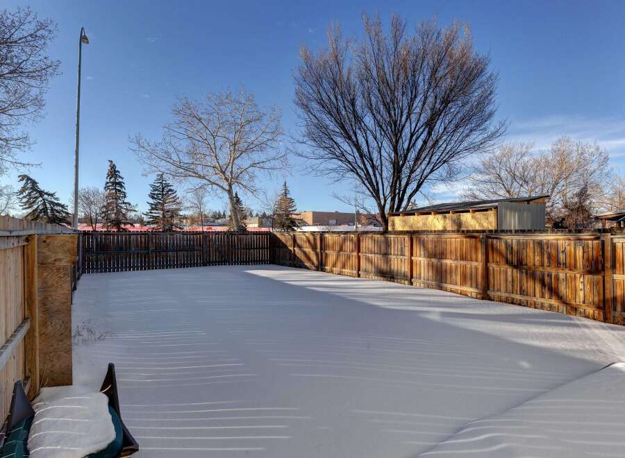 Enjoy the tranquility of this spacious backyard, perfect for outdoor activities.