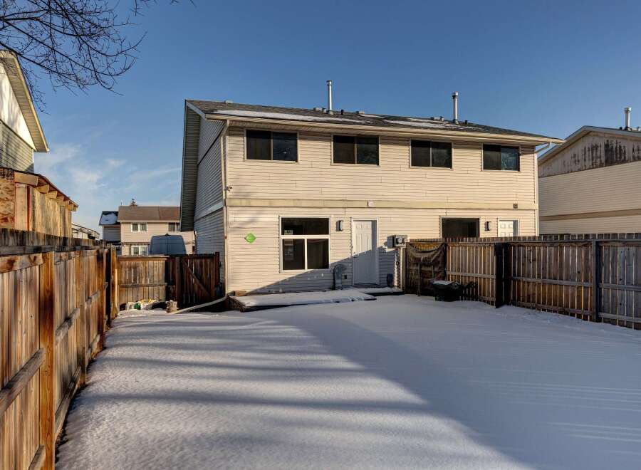 This charming two-story home boasts a spacious backyard, perfect for outdoor activities.