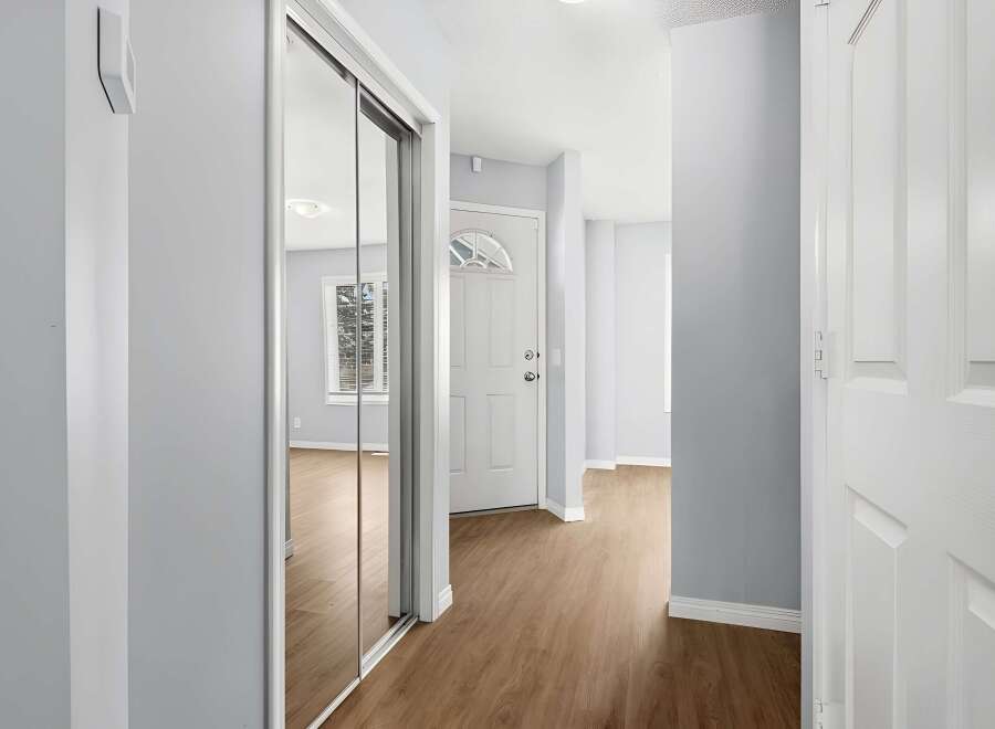 Step into this inviting entryway, featuring a modern design with sleek lines and neutral tones.