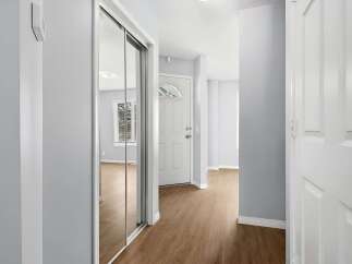 Step into this inviting entryway, featuring a modern design with sleek lines and neutral tones.