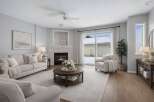 Step into this inviting living space, featuring a cozy fireplace and ample natural light.