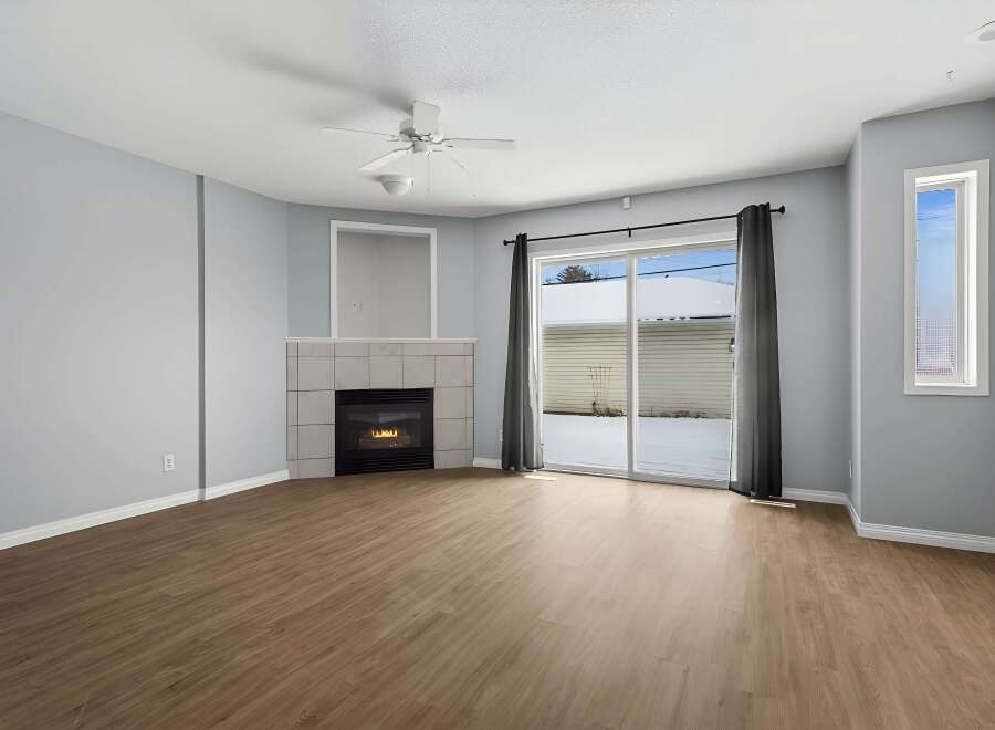 Step into this inviting living space, featuring a cozy fireplace and abundant natural light.