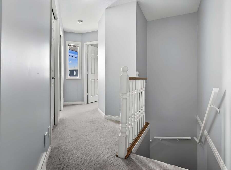 This stunning property features a bright and airy hallway with a staircase.