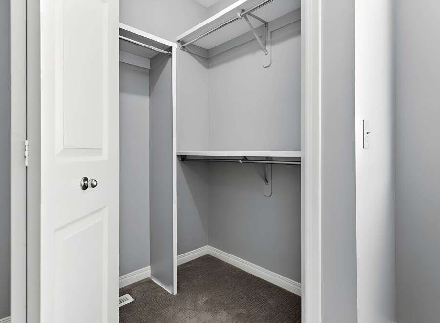 Step into this well-organized closet, offering ample storage space for your wardrobe.
