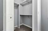 Step into this well-organized closet, offering ample storage space for your wardrobe.