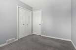 Discover the potential of this inviting space! This room features two white doors, offering ample storage and a clean aesthetic.