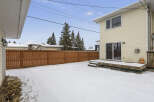 Enjoy the winter wonderland in this charming property! This home features a spacious backyard covered in snow, perfect for outdoor activities.
