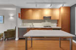 This modern kitchen boasts sleek wooden cabinetry, offering ample storage and a warm aesthetic.